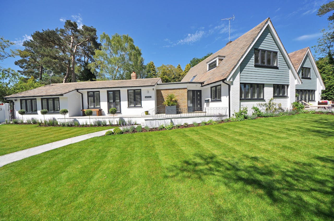 Crafting Captivating Headlines: Your awesome post title goes here Contemporary house exterior with large manicured lawn and beautiful garden.