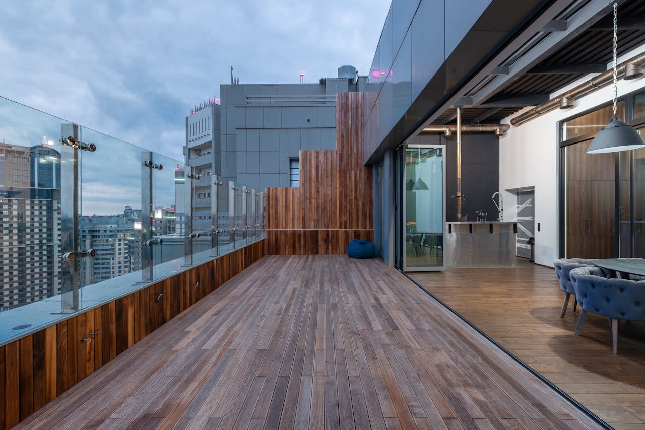 About Empty spacious terrace with wooden floor and walls placed in modern apartment in cloudy day